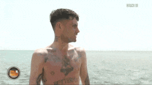 a shirtless man with a tattoo on his chest that says " butterfly "