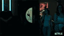 two women in a dark room with a netflix logo behind them