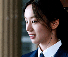 a close up of a woman 's face in a suit and tie