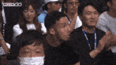 a group of people sitting in a stadium with the word rizin 44 on the top