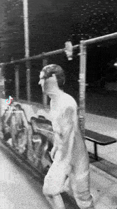 a black and white photo of a man in a white suit with tiktok written on the bottom