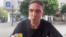 a man in front of a store that says o2