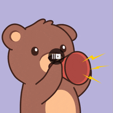 a brown teddy bear is holding a red object in its mouth with a video playing in the background