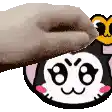 a person is holding a donut over a cat 's face .