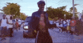 a man without a shirt is dancing in front of a group of people