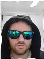 a man with a beard wearing sunglasses and a black hood