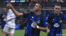 a group of soccer players celebrate a goal during a game