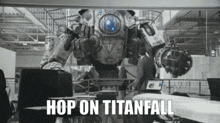 a man is sitting in front of a robot that says hop on titanfall .