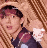 a young man wearing glasses and a teddy bear hat with the words intak and xiare below him