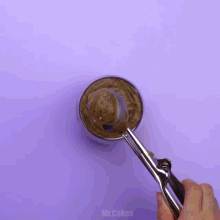 a glass of chocolate mousse on a saucer on a purple table