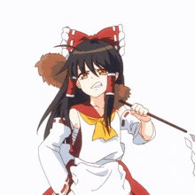 a girl with a red bow on her head holds a stick