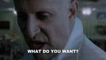 a close up of a man 's face with the words what do you want behind him