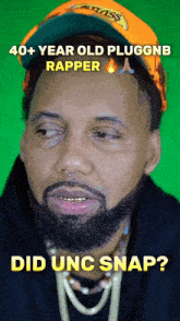 a man with a beard wearing a hat with the words 40+ year old pluggne rapper did unc snap