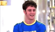 a young man wearing a blue shirt that says brasil