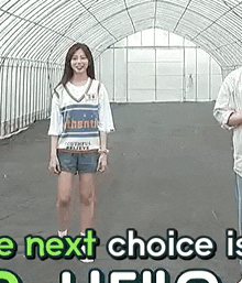 a woman and a man are standing next to each other in a greenhouse .