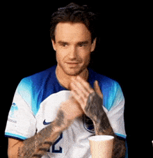 a man wearing a blue and white shirt with the number 24 on it