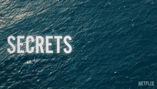 a poster for secrets do n't die shows a body of water