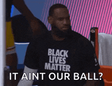 lebron james is wearing a black t-shirt that says `` it ain t our ball '' .