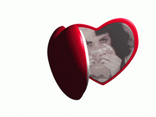 a red heart shaped mirror with a picture of a woman on it