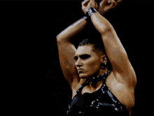 a woman in a wrestling ring with her hands up