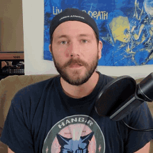 a man with a beard wears a black hat that says under armour on it