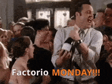 a man in a suit and tie is dancing in a crowd with the words " factorio monday " written on the bottom