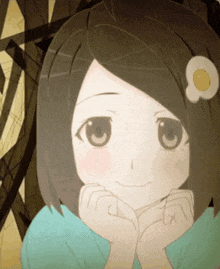 a girl with a flower in her hair is smiling with her hands on her face