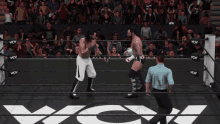 two wrestlers are standing in a ring with a sign that says " aoa " on it