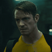 a man wearing a yellow shirt with a star trek logo