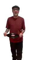a man in a red shirt is holding a record in his hands