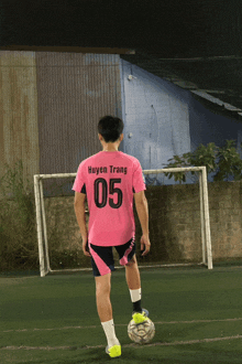 a soccer player wearing a pink shirt with the number 05