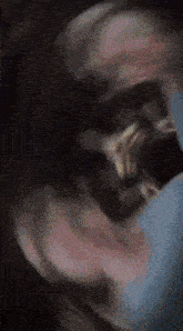 a blurry image of a person 's face with a red light in the corner