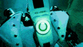 a close up of a pen with a green button on it