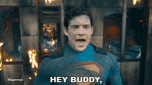 a superman says " hey buddy " in front of a burning building