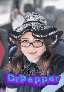 a woman wearing glasses and a hat with the words love dr pepper written on it