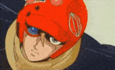 a close up of a person wearing a red helmet with the letter o on it