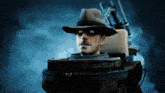 a man wearing a hat and a mask is tied to a wooden barrel