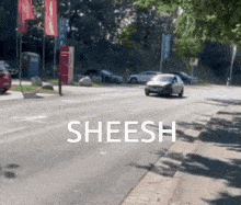 a car is driving down a street with the word sheesh on the side of it