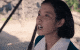 a close up of a woman 's face with a surprised look on her face