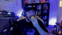 a man wearing headphones is eating a lemon in a room with a sub count of 55/50