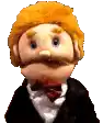 a puppet with red hair and a mustache is wearing a suit and tie .