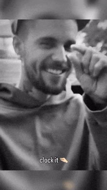 a black and white photo of a man with the words " clock it " below him