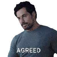 a man with a beard is wearing a shirt that says agreed on it