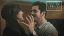 a man kissing another man with torloni news written on the bottom