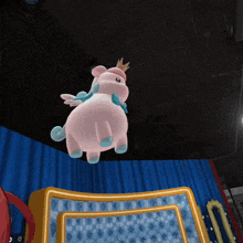 a stuffed animal with wings and a crown on its head