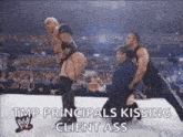 a wrestler is kissing another wrestler 's butt while another wrestler is kneeling down .