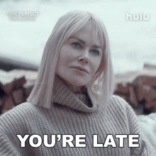 an advertisement for nine perfect strangers shows a woman wearing a sweater and says you 're late