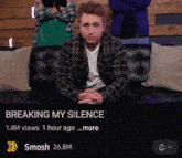 a man in a plaid shirt sits on a couch with the words " breaking my silence " on the top