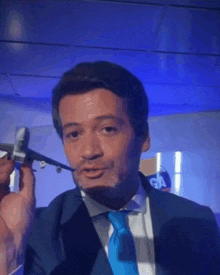 a man in a suit and tie holds a model airplane