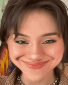 a close up of a woman 's face with a smiley face .